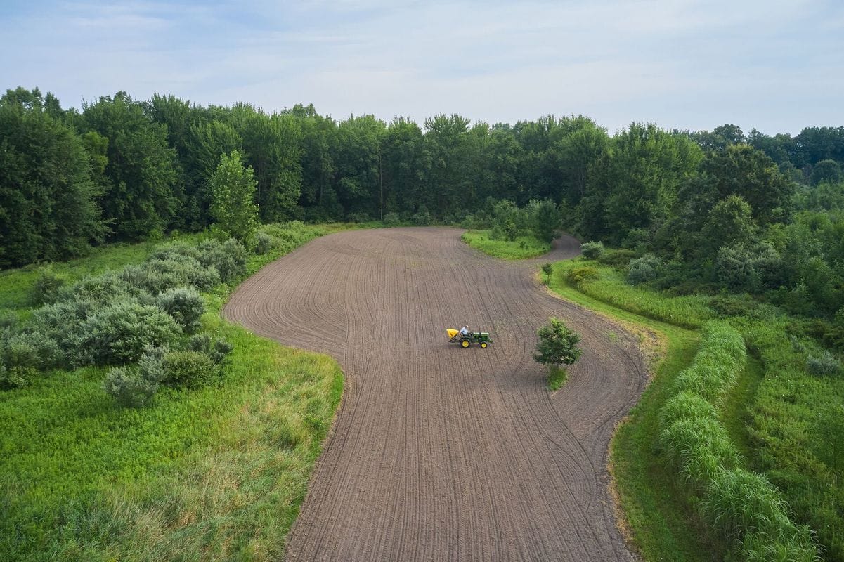 Overhead view of tractor on land, how to ask for hunting permission concept. 