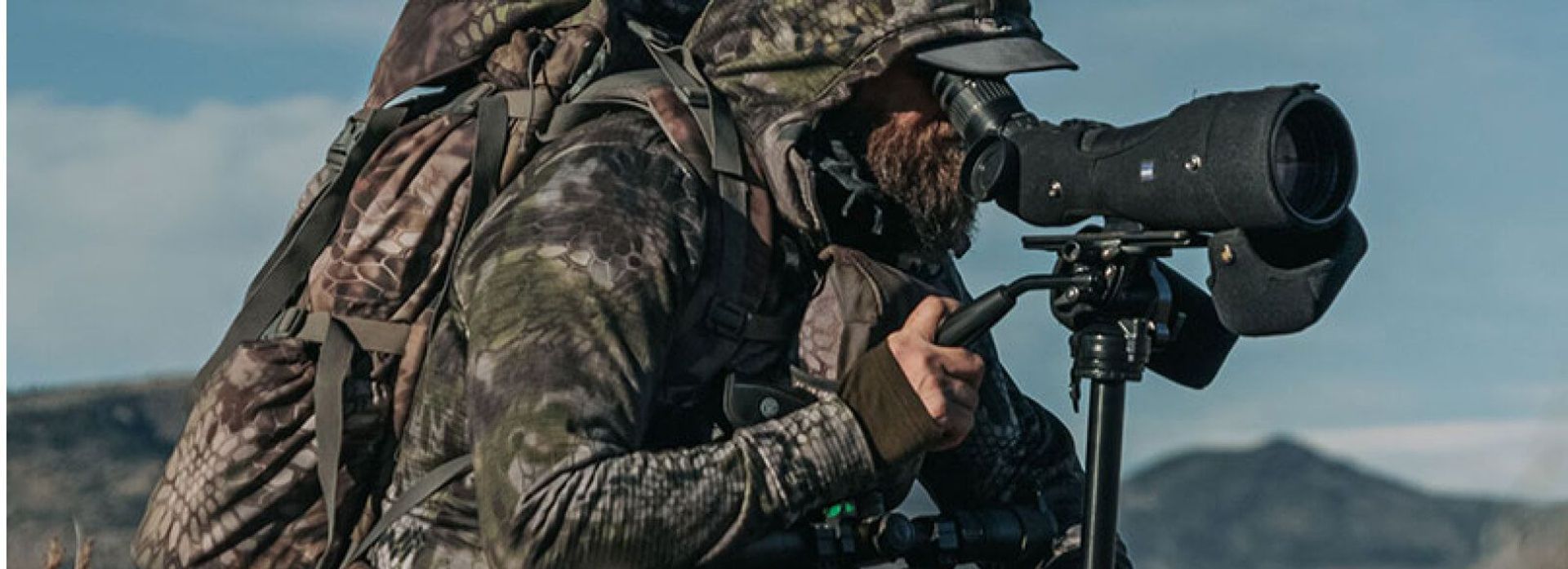 A hunter in camp use a spotting scope, best spotting scopes concept.