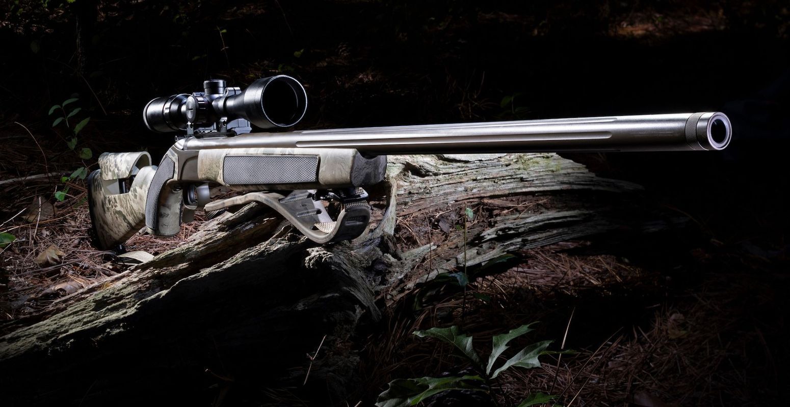 Muzzleloader with scope on log, how to hunt with a muzzleloader concept.