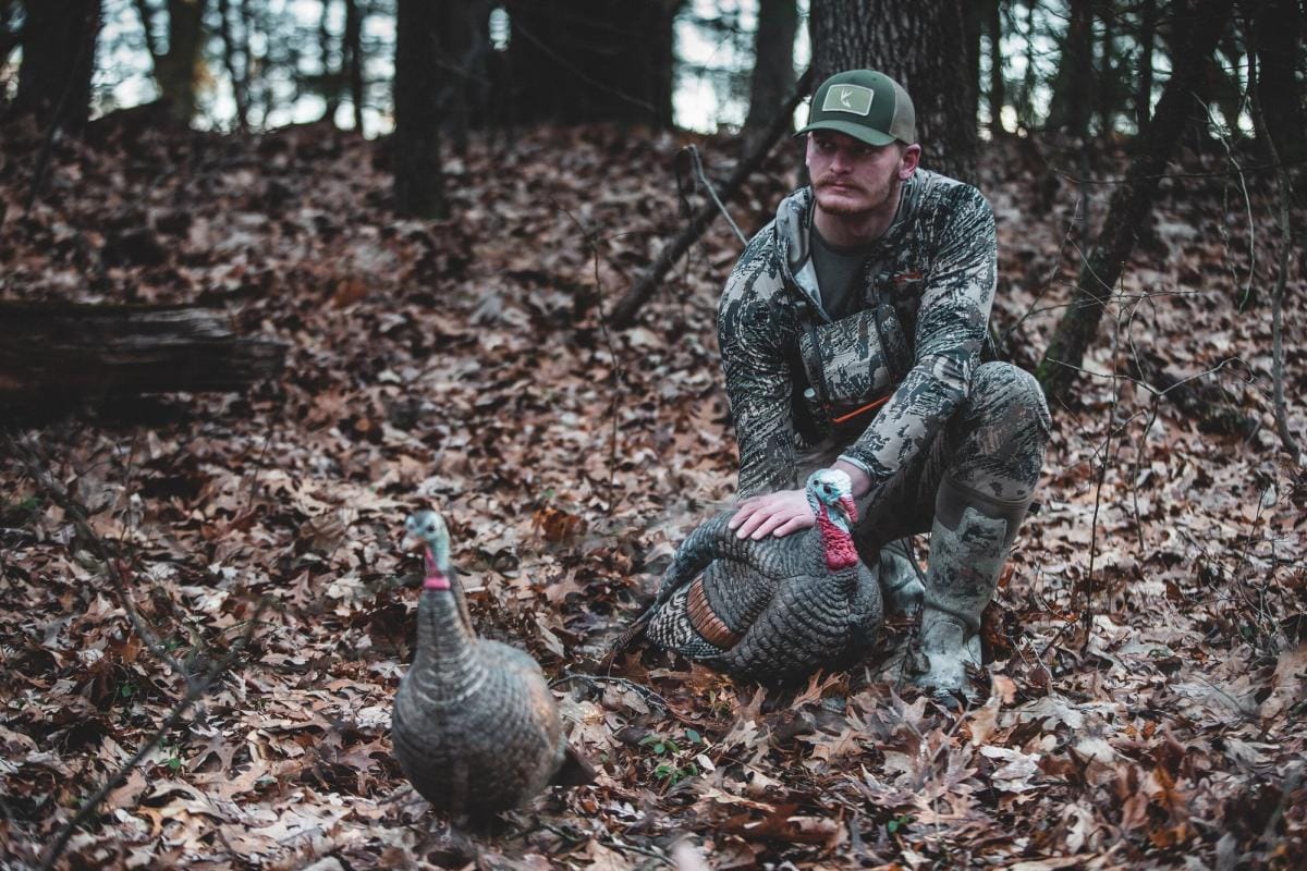 A hunter with a turkey, turkey hunting concept.