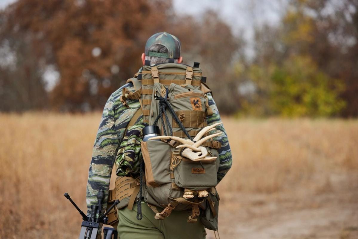 A hunter carries a pack with antler sheds, where to find deers sheds concept.