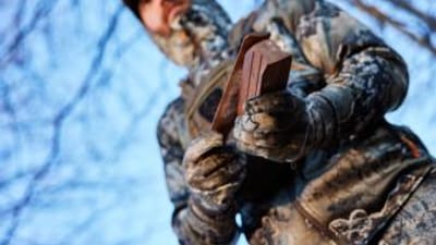 Close-up of a turkey box call in a hunter's hands, turkey box call techniques concept.