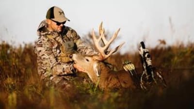 A hunter holds a deer's head and antlers after hunt, what diseases do deer carry concept.
