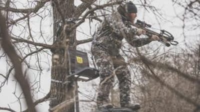 A hunter in a hang-on tree stand.