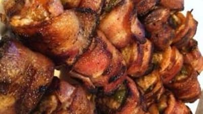 Close-up of bacon wrapped turkey rolls, wild game appetizers concept.