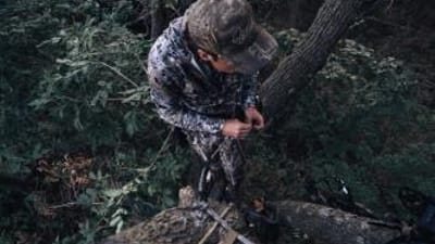 A hunter in a tree, best hunting saddles concept.