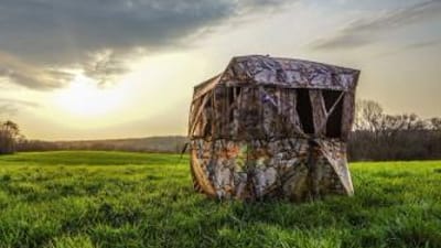 A ground blind in a field.