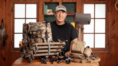 Early season hunting gear spread on a table with a hunter.