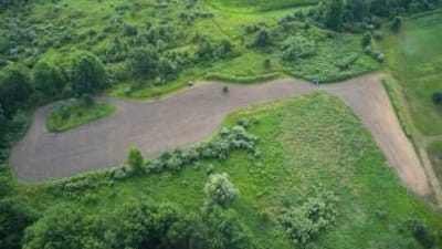 Aerial view of tractor on farmland, find property lines for hunting concept. 