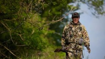 A hunter in the woods, when is turkey season Minnesota concept.