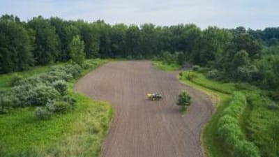Overhead view of a tractor on farm land, how to find property lines in South Carolina concept. 