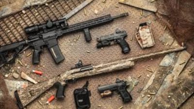 Various firearms on a table, dry fire drills concept.