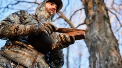 A hunter with a turkey call ready for Michigan turkey season.