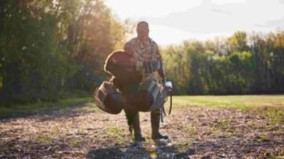 A hunter with a turkey after a hunt, when is NC turkey season concept.