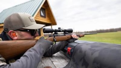 Hunter aims bolt action rifle, understanding bolt action rifle calibers concept.