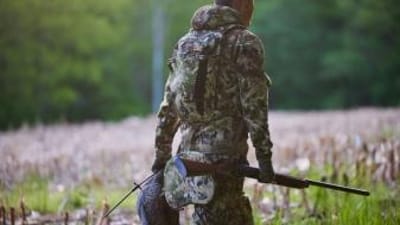 A hunter carries a turkey decoy into the field.