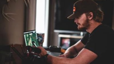 A man looks at a computer with HuntWise on the screen, e scouting for elk concept.