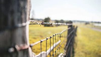 Close-up of a wire fence, how to find property lines in Nebraska concept. 