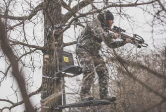 A hunter in a hang-on tree stand.