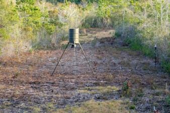 A deer feeder in a field.