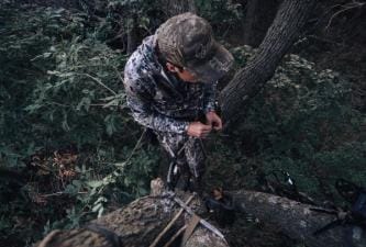A hunter in a tree, best hunting saddles concept.