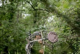 A hunter carries a tree stand, hang on treestand vs climber concept.