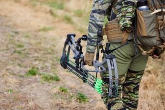 Hunter carrying hunting gear for deer hunts.