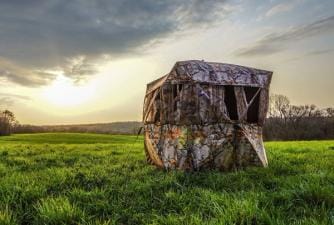 A ground blind in a field.
