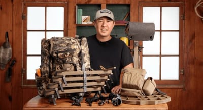 Early season hunting gear spread on a table with a hunter.