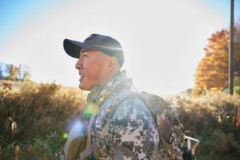A hunter outdoors in gear, whaat can you hunt in summer concept.