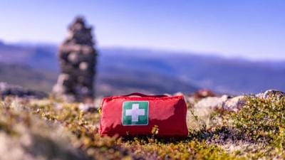 A first aid kit on the ground, hunting first aid kit concept.