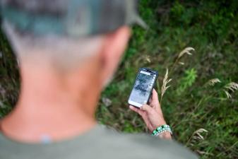 Hunter using the HuntWise land app to find where to hunt.