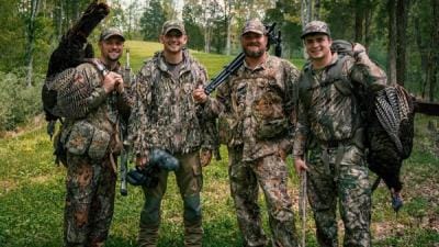 The four members of The Untamed wearing hunting camo.