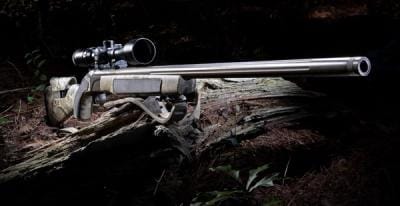 Muzzleloader with scope on log, how to hunt with a muzzleloader concept.