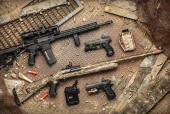 Various firearms on a table, dry fire drills concept.