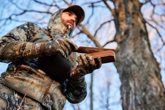 A hunter with a turkey call ready for Michigan turkey season.