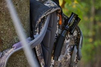 A deer grunt call on a hunter's pack, use the best deer grunt call tips concept.