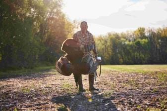 A hunter with a turkey after a hunt, when is NC turkey season concept.