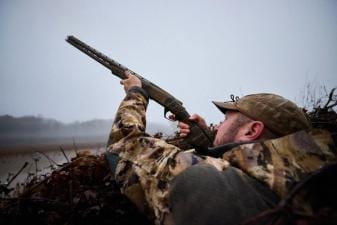 Hunter aiming a shotgun for duck hunt, MN duck opener 2025 concept.