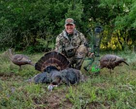 John Dudley with a turkey and decoys after turkey hunting.