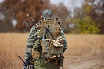 A hunter carries a pack with antler sheds, where to find deers sheds concept.