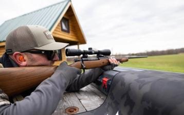 Hunter aims bolt action rifle, understanding bolt action rifle calibers concept.