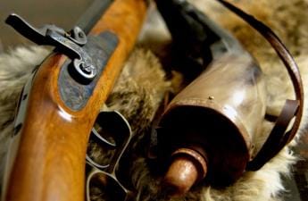 Close up of a muzzleloader and accessories.