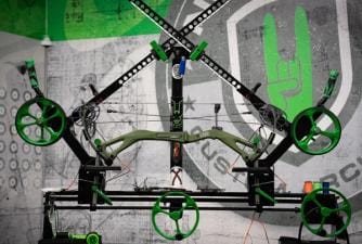 A compound bow on a stand for maintenance.